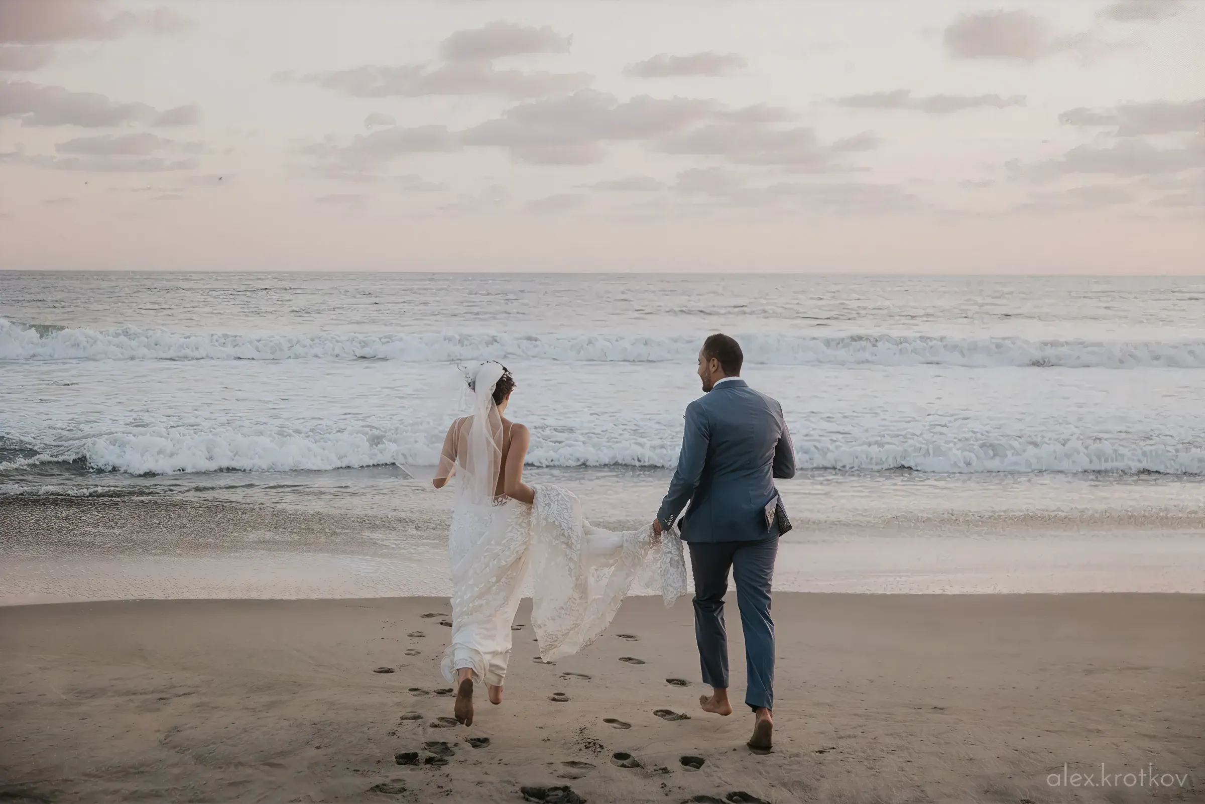 Married couple running to the sea